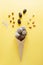 Homemade energy balls in ice cream cone and ingredients for cooking on yellow background. Healthy tasty food sweets substitute