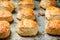 Homemade English cheese rolls on baking sheet.