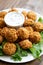 Homemade falafel with yogurt sauce close up