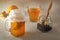 Homemade fermented drink Kombucha in glass jars with lemon on a wooden table.