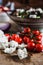 Homemade feta cheese with cherry tomatoes and greek salad background on wooden table