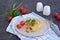 Homemade fillet Cordon Bleu or chicken fillet with ham and cheese on a white clay plate on a dark brown background. Swiss cuisine