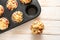 Homemade finger food as party snack, pizza muffins baked in a tray on a wooden table, high angle view from above, copy space