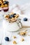 Homemade fitness granola with yoghurt and berries on white kitch