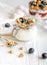 Homemade fitness granola with yoghurt and berries on white kitchen background