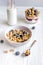 Homemade fitness granola with yoghurt and berries on white kitchen background