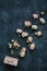 Homemade floral soap. Natural soap and rose flowers on dark background. Spa concept, body care products. Flat lay, top view