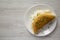 Homemade Fluffy Omelet on a white plate on a white wooden surface, top view. Flat lay, overhead, from above. Copy space