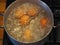 Homemade food. Chicken eggs are cooked in a saucepan over a fire. Preparing a filling for pies