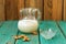 Homemade fresh almond milk in glass jar with empty glass bowl an