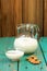 Homemade fresh almond milk in glass jar and glass bowl and whole