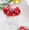 Homemade fresh chia pudding with yogurt, strawberry, raspberry, nuts and coconut in a glass