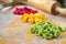 Homemade fresh colored pasta on wooden background