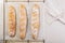 Homemade fresh mouth-watering sourdough baguettes. Homebaked bread. Top view. Copy space