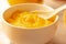 Homemade fresh pudding or tangy lemon curd in a white bowl.Close-up