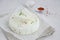 Homemade fresh soft cheese brynza or feta with chilli and sea salt on a light background. Horizontal, copy space