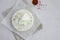 Homemade fresh soft cheese brynza or feta with chilli and sea salt on a light background. Horizontal, top view, copy space