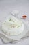Homemade fresh soft cheese brynza or feta with chilli and sea salt on a light background. Vertical, copy space