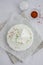 Homemade fresh soft cheese brynza or feta with chilli and sea salt on a light background. Vertical, copy space