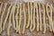 Homemade fresh uncooked Italian pasta fusilli with flour on wooden background