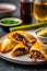 Homemade freshly baked Argentinian beef empanadas turnover pies on a plate served with chimichurri sauce. Latin American cuisine