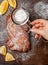 Homemade freshly baked braided Wicker pie with lemon jam. Woman decorates cake with powdered sugar