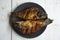 Homemade fried goldfish on a black plate on a wooden table