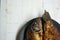 Homemade fried goldfish on a black plate on a wooden table