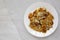 Homemade Fried Hashbrowns on a white plate, top view. Copy space