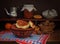 Homemade fried patties in a ceramic bowl, walnuts and dishes on a wooden table.