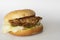 Homemade fried pork hamburger on white paper background.