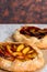 Homemade galettes with peaches and plums with sesame. Sweet fruit pies. Vegetarian dessert. Closeup. Selective focus