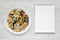 Homemade german Kaiserschmarrn pancake on a white plate, blank notepad on a white wooden surface, top view. Flat lay, overhead,