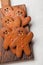 Homemade ginger biscuits in the shape of gingerbread men for Halloween. On the lighter concrete background. Top view