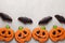 Homemade ginger cookies in the shape of pumpkins and bats on Halloween. On the lighter concrete background. Top view with copy spa