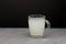 Homemade ginger Kombucha or milk-white kvass in a large glass mug. Healthy fermented drink. Dark background, copy space