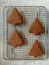 Homemade gingerbread Christmas cookies cooling on metal rack