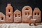 Homemade gingerbread town standing in row with Christmas deer sprinkled with powdered sugar on black background