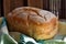 Homemade glutenfree bread with brown crispy crust on green dishcloth