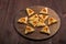 Homemade gomentashi cookies for the Jewish holiday of Purim on a chalkboard are laid out in the form of magen David on