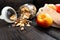 Homemade granola in glass jar and apples in reusable fabric bag on dark wooden table with texture. Healthy breakfast concept and