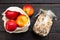 Homemade granola in glass jar and apples in reusable fabric bag on dark wooden table with texture. Healthy breakfast concept and