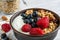 Homemade granola with greek yogurt, nuts and fresh berries