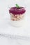 Homemade granola parfait with berry jam and mint, yogurt and muesli cereal as healthy breakfast food in the morning, organic dairy