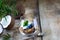 Homemade granola in a transparent glass, blueberries, chips and coconut and mint on a wooden background. Healthy fresh natural