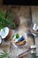 Homemade granola in a transparent glass, blueberries, chips and coconut and mint on a wooden background. Healthy fresh natural