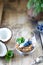 Homemade granola in a transparent glass, blueberries, chips and coconut and mint on a wooden background. Healthy fresh natural