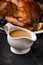 Homemade gravy in a sauce dish with turkey