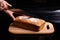 Homemade gray bread on a black background. Photo in section.