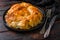 Homemade Greek spanakopita in on black plate  filo spinach eggs feta side view on dark wooden background